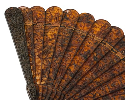 Lot 558 - A Chinese Canton carved tortoiseshell brise fan.