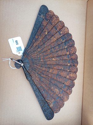 Lot 558 - A Chinese Canton carved tortoiseshell brise fan.