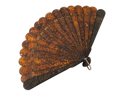 Lot 558 - A Chinese Canton carved tortoiseshell brise fan.