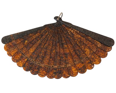 Lot 558 - A Chinese Canton carved tortoiseshell brise fan.