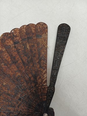 Lot 558 - A Chinese Canton carved tortoiseshell brise fan.