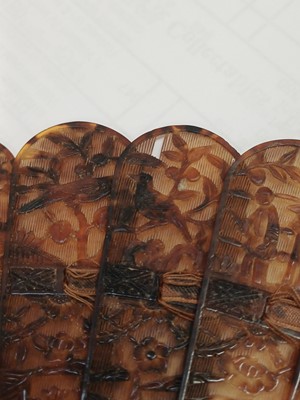 Lot 558 - A Chinese Canton carved tortoiseshell brise fan.