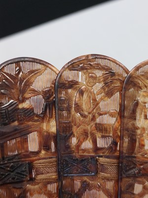 Lot 558 - A Chinese Canton carved tortoiseshell brise fan.