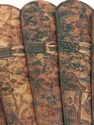 Lot 558 - A Chinese Canton carved tortoiseshell brise fan.