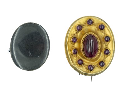 Lot 222 - A Victorian Etruscan Revival high-purity gold cabochon garnet set oval brooch.