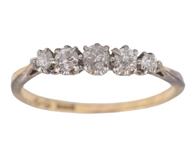 Lot 240 - An 18k diamond set graduated five-stone half-hoop ring.