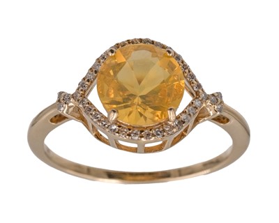 Lot 181 - A 14k yellow gold and natural fire opal and diamond ring.