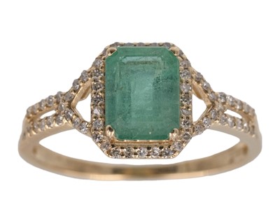 Lot 193 - A 14k yellow gold emerald-cut emerald ring.