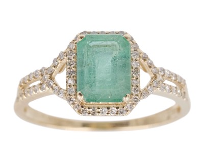 Lot 246 - A 14k yellow gold emerald-cut emerald ring.