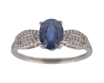 Lot 188 - A 950 platinum and oval-cut sapphire and diamond ring.