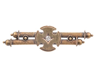 Lot 187 - A Victorian 15k Etruscan Revival double-bar brooch, set with an old mine-cut diamond.