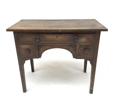 Lot 3012 - A George III provincial oak lowboy, fitted...