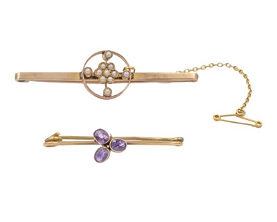 Lot 237 - Two 9k bar brooches, one set with amethyst, the other seed pearls.