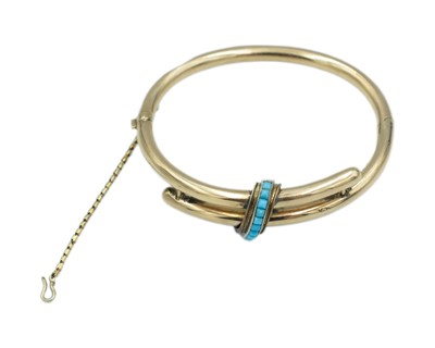 Lot 246 - A Victorian gold hinged hollow bangle with a turquoise-set band.