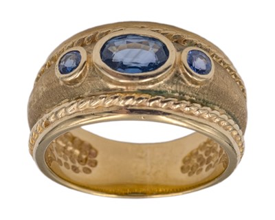 Lot 247 - A modern 9k gold and blue sapphire three-stone Byzantine band ring.