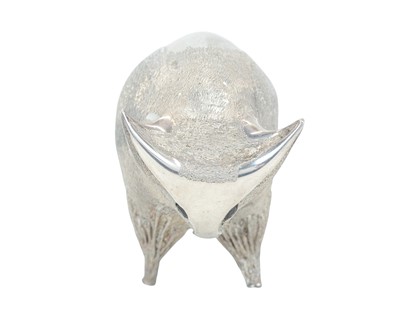 Lot 149 - A cast silver figure of a stylized bull.
