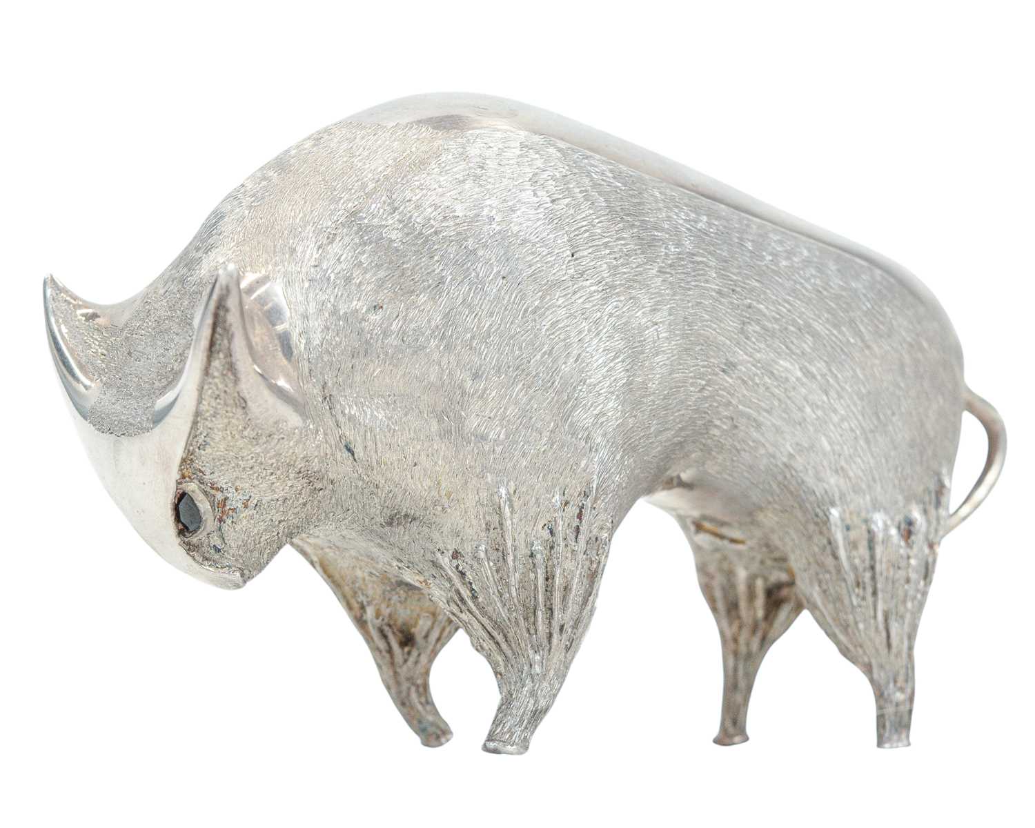Lot 149 - A cast silver figure of a stylized bull.