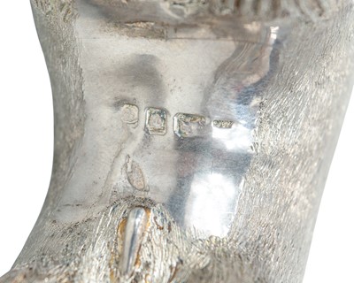 Lot 149 - A cast silver figure of a stylized bull.