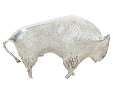 Lot 149 - A cast silver figure of a stylized bull.