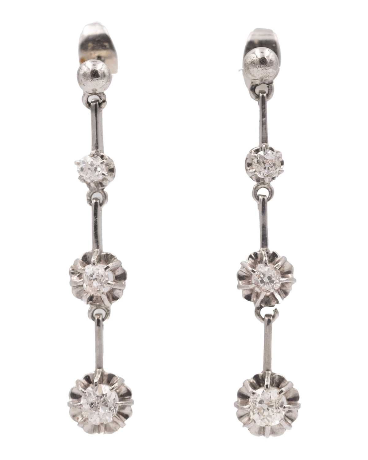 Lot 7 - An early 20th-century pair of platinum and diamond set knife-edge bar pendant earrings.