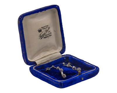 Lot 7 - An early 20th-century pair of platinum and diamond set knife-edge bar pendant earrings.