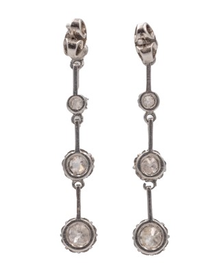 Lot 7 - An early 20th-century pair of platinum and diamond set knife-edge bar pendant earrings.