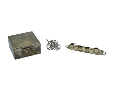Lot 75 - A selection of silver, to include a cigarette box, miniature tricycle and Edwardian dolls teaset.