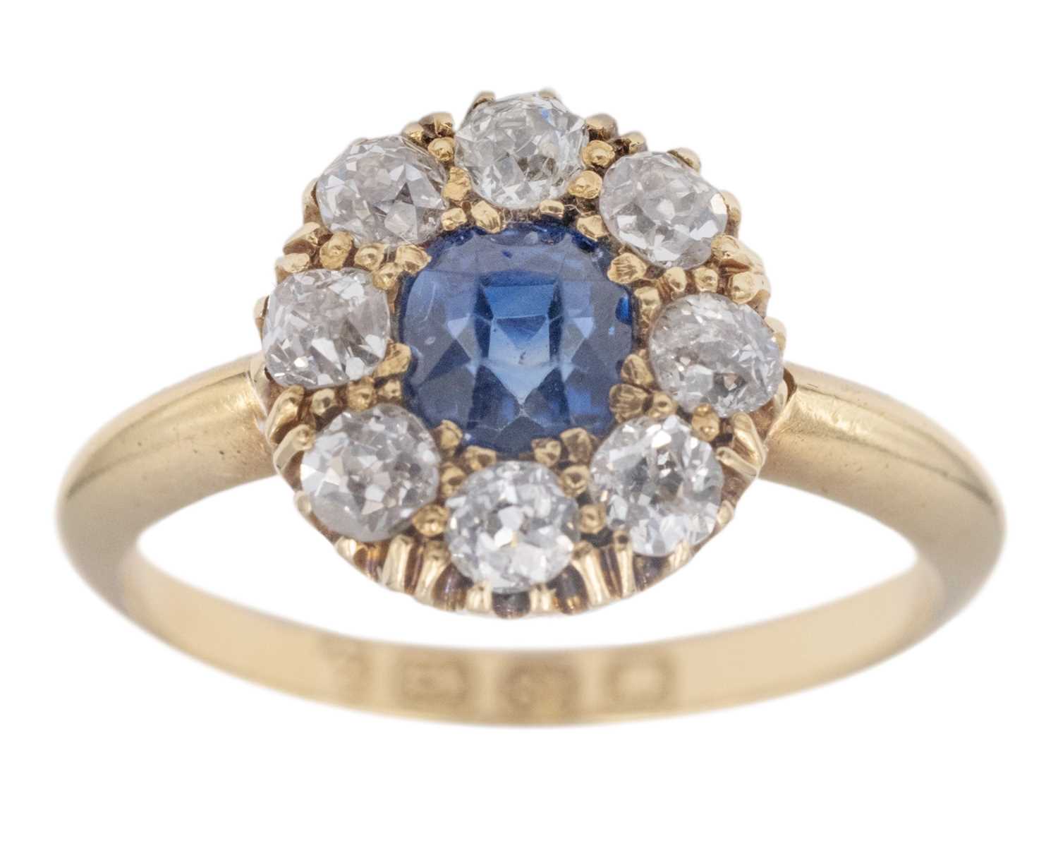 Lot An attractive Victorian 18k diamond and cushion-cut blue sapphire set cluster ring.