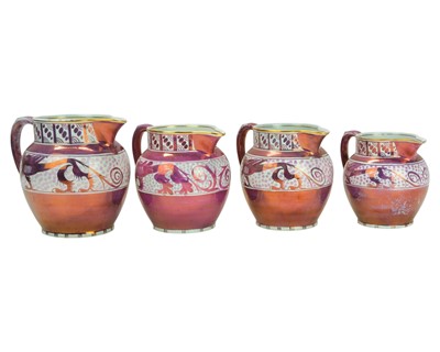 Lot 65 - A graduated set of three A E Gray & Co Gloria Lustre jugs, by Hilda Lockett.