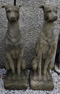 Lot 756 - A pair of composition stone sculptures of seated greyhounds.