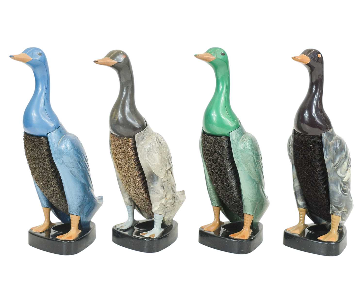 Lot 19 - Four mid-century early plastic 'Dandy Duck' novelty clothes brushes with stands.
