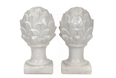 Lot 697 - A pair of white glazed pottery artichokes.