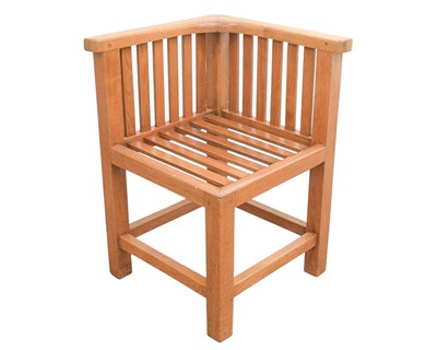 Lot 121 - An Arts and Crafts style teak corner garden or conservatory chair.