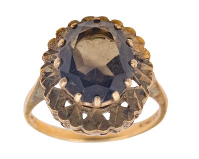 Lot 27 - A 9k oval smoky quartz set cocktail ring.