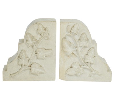 Lot 24 - A pair of carved stone bookends.