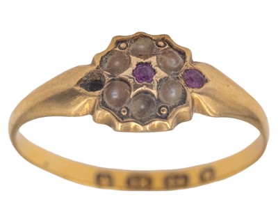 Lot 19 - A dainty Victorian 18k hallmarked gold ruby and seed pearl set daisy ring.