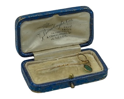 Lot 248 - An early 20th-century yellow metal stock pin, the head modeled in wire as spectacles.