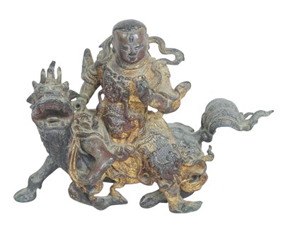 Lot 530 - A Chinese cast group of a figure on a qilin.