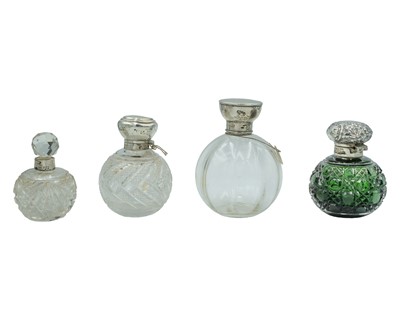 Lot 113 - A selection of globe-shaped silver-mounted perfume bottles.
