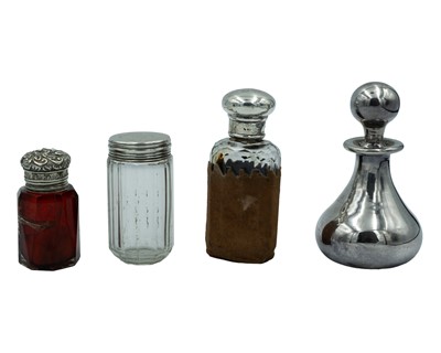 Lot 68 - Four Victorian and later silver-mounted scent bottles and cosmetic pots.