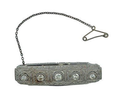 Lot 13 - An Art Deco platinum diamond set bar brooch.
