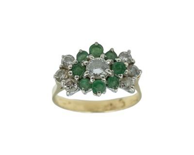 Lot 54 - A diamond and emerald set cluster ring, set in yellow and white gold.