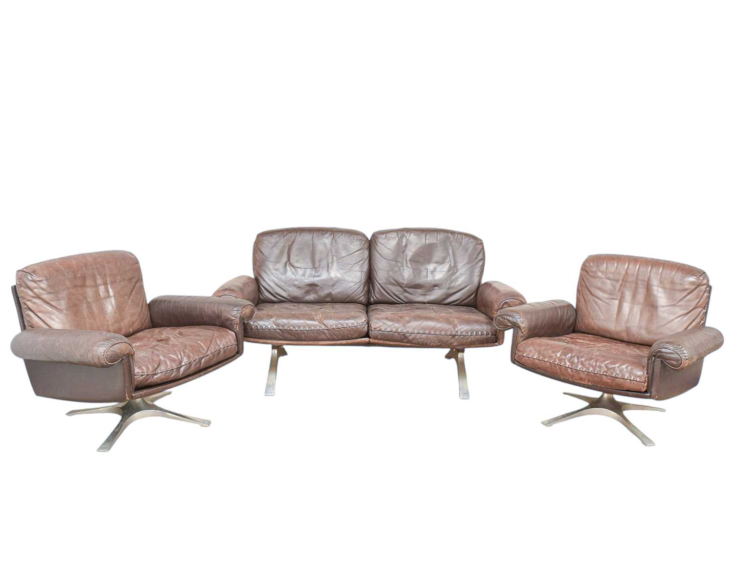 Lot 254 - A brown leather De Sede DS-31 sofa and two swivel chairs.