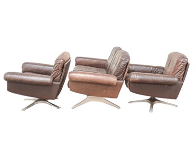 Lot 254 - A brown leather De Sede DS-31 sofa and two swivel chairs.