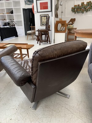 Lot 254 - A brown leather De Sede DS-31 sofa and two swivel chairs.