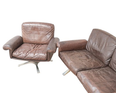 Lot 254 - A brown leather De Sede DS-31 sofa and two swivel chairs.