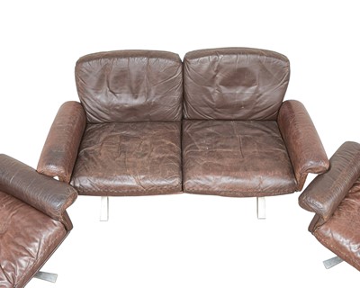 Lot 254 - A brown leather De Sede DS-31 sofa and two swivel chairs.