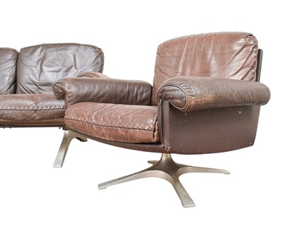 Lot 254 - A brown leather De Sede DS-31 sofa and two swivel chairs.