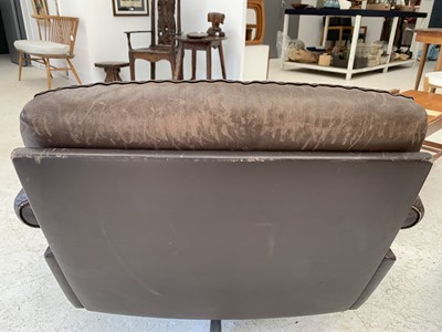 Lot 254 - A brown leather De Sede DS-31 sofa and two swivel chairs.