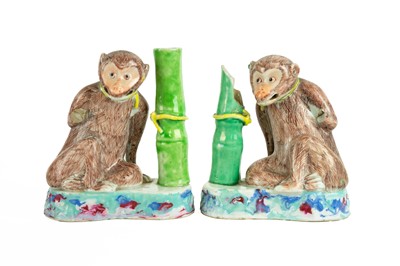 Lot 557 - A pair of Chinese export monkey spill vases.